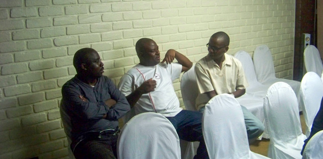 Kingsley Gwaza, Datacom MD Moses Nthakomwa and Mtisunge Mipando sharing notes before the event started.